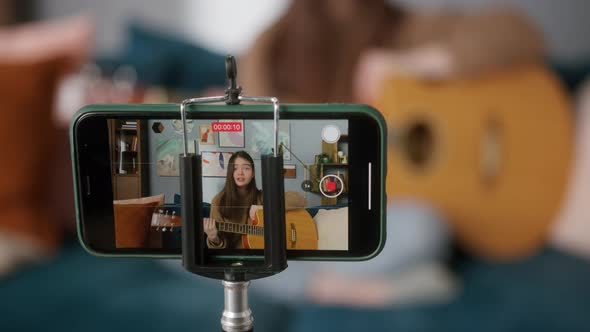 Music Blogger is Playing Guitar Shooting Herself on Video