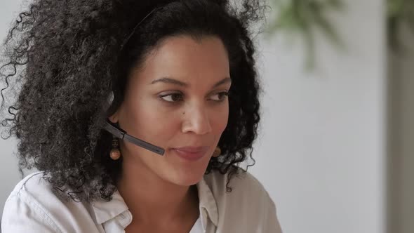 Portrait of Young African American Woman Talking on Video Conference Call Using Headset