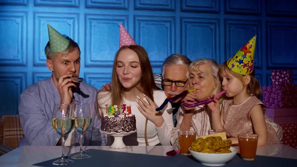 Happy Birthday Woman Blowing Candles on Cake Making Wish Having Fun Celebrating Party with Family