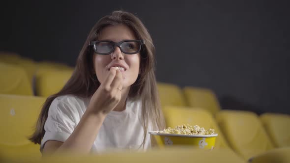 Single Beautiful Woman Watching 3d Film in Cinema and Eating Popcorn. Portrait of Happy Caucasian