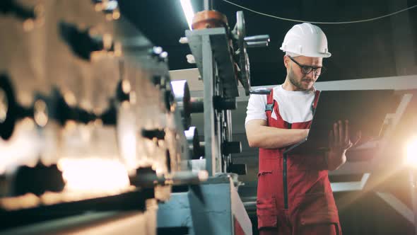 Metalworking Factory Unit with a Male Engineer at Work