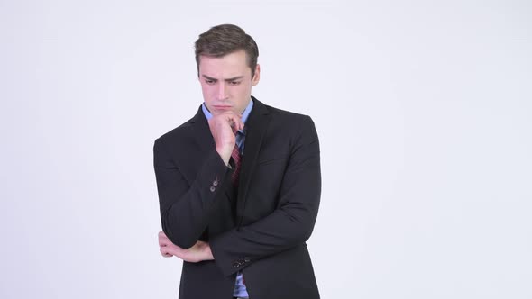 Young Serious Businessman Thinking While Looking Down