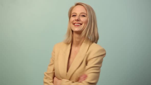 Beautiful smiling woman in jacket on blue background