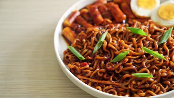 Jjajang Rabokki - Korean instant noodles or Ramyeon with Korean rice cake or Tteokbokki and egg in b