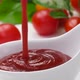 Pouring ketchup in bowl on white background with fresh tomatoes - VideoHive Item for Sale