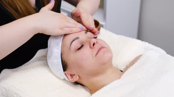 Woman Gets Face Massage in Spa Salon