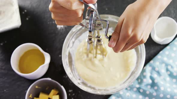 Woman whisking batter in a bowl 4k