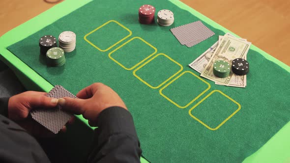 Closeup Hands of a Risky Poker Player Slowly Reveal Their Cards