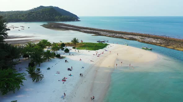 Small boats surrounding sandy islet on the north coast of Thailand. Malibu beach, Koh Phangan