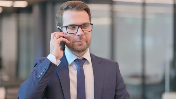 Portrait of Businessman Talking on Phone