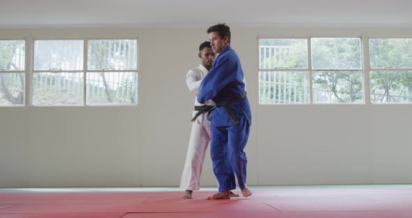 Judokas training by doing a randori on the judo mat