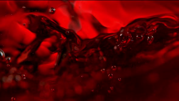 Super Slow Motion Macro Abstract Shot of Swirling Red Wine in Glass at 1000Fps.