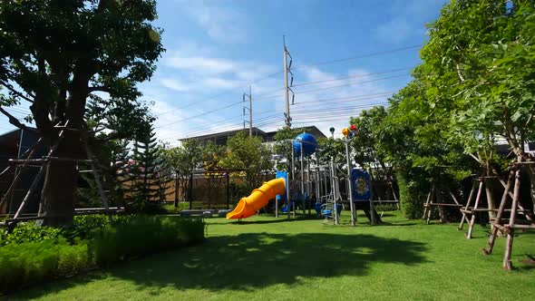 Colorful Children Playground In The Garden On Sunny Day