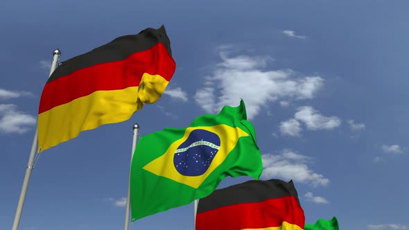 Waving Flags of Brazil and Germany on Sky Background alt