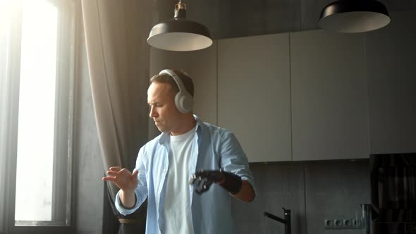 Joyful man with artificial bio hand prothesis pretends playing piano