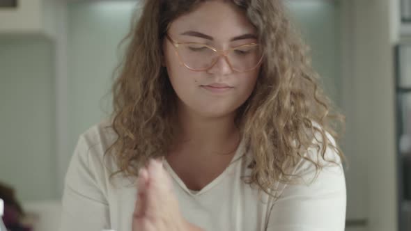 Portrait of Caucasian Woman Disinfecting Hands with Sanitizer Before Taking Apple. Young Chubby Lady