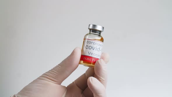 Vaccine Covid-19 Glass Bottle In Medical Doctor Hand