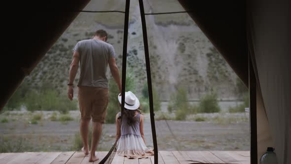 A Girl and a Guy Travelers are Resting in a Tent Box a Young Man Goes Out and Sits on the Terrace