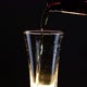 Pouring beer from the bottle into a rotating glass - VideoHive Item for Sale