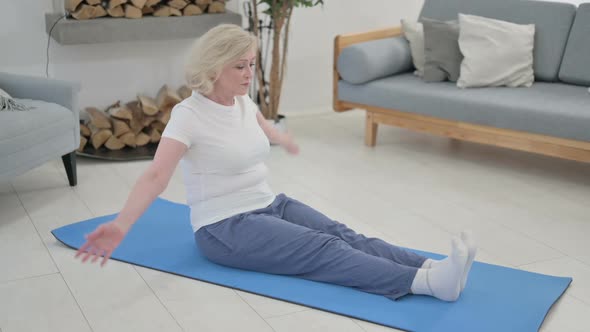Old Woman Doing Stretches on Yoga Mat at Home