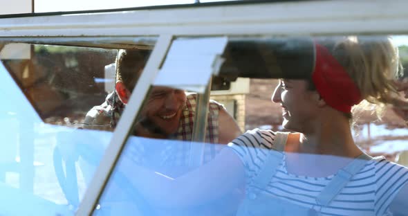 Couple interacting with each other near a car 4k