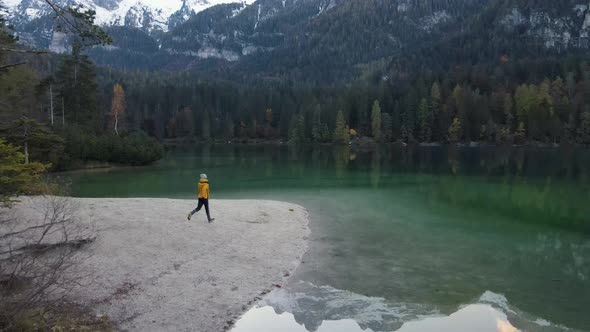 Person Running on Lake Shore - Lake Tovel, Trentino, Mountain Lake, Yellow Jacket, Autumn - 4K 60fps