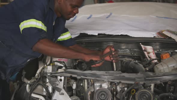 African man repairing car