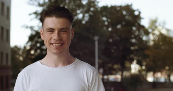 Portrait of Young Caucasian Man Brunette Friendly Looking To Camera. Close Up of Millennial Teen Guy