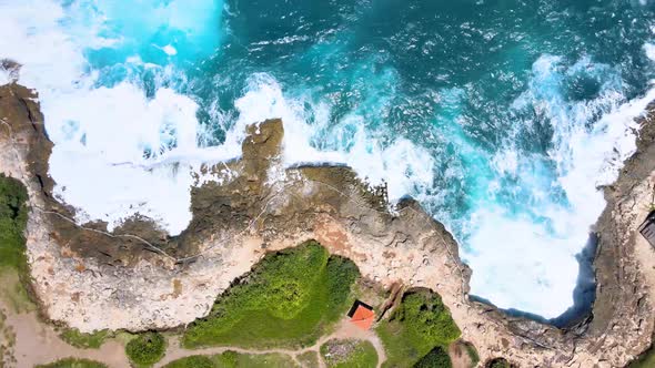 Wave breaks at Devil's Tear Nusa Lembongan