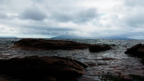 Low to the ground drone shot of ocean waterscape. Aerial video shot by a drone. Mallaig, Scotland, I