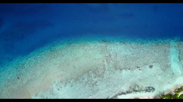 Aerial above seascape of idyllic bay beach vacation by shallow ocean with white sand background of j