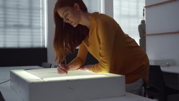 Caucasian woman working in fashion office