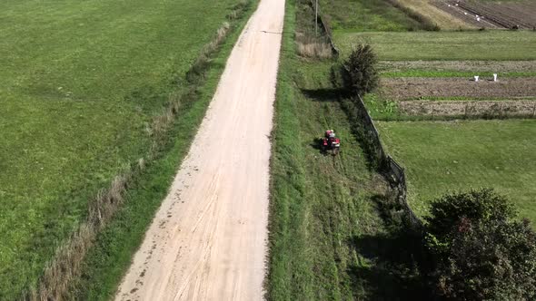 Farmer Digs Potatoes with a Small Tractor