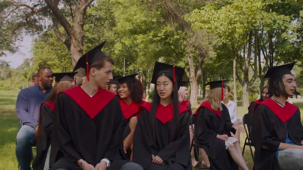 Portrait of Diverse Multiracial Graduates in Academic Dresses on Graduation Day