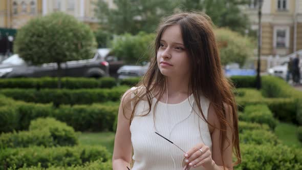 Young Woman Puts on Sunglasses