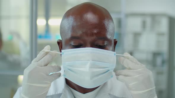 Portrait of African American Scientist Wearing Mask and Glasses in Lab