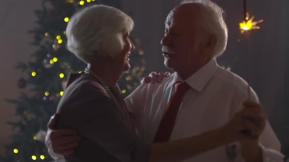 Cheerful Grandparents Dancing on Christmas Eve