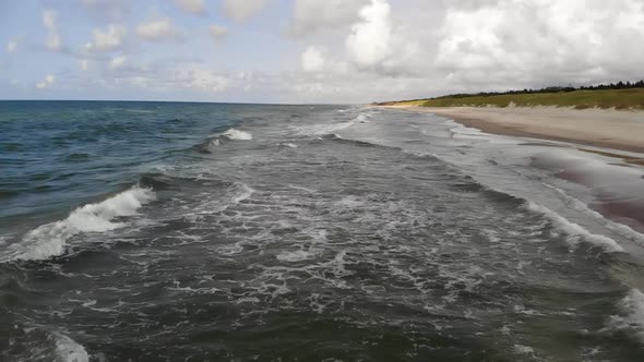 AERIAL: Drone Shot of Sandy Beach and Sea on a Beautiful Sunny Day