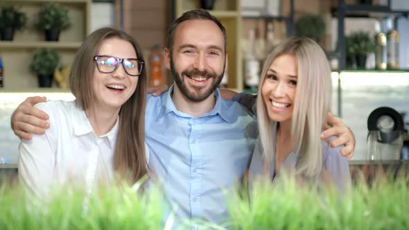 Group of Young Business Friends Smiling and Hugging Posing for Photo Medium Shot