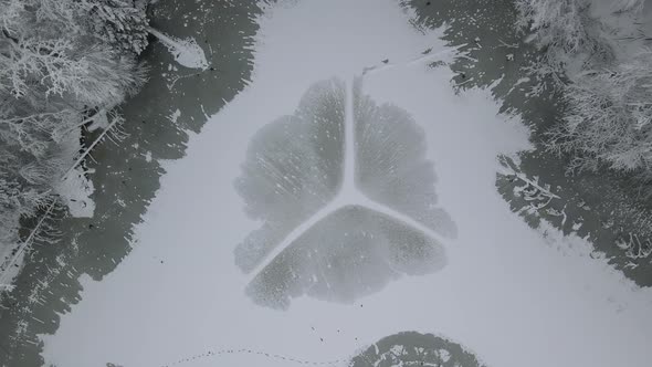 Frozen Stream In The Center Of The Forest In Poland - aerial shot