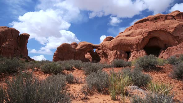 Time lapse in the Utah desert of clouds moving over Arches National Park