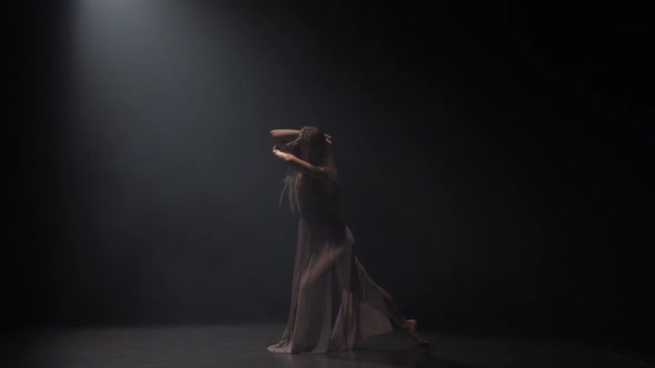 Slow Motion of Sporty Lady Practicing Contemp in Dark Studio.