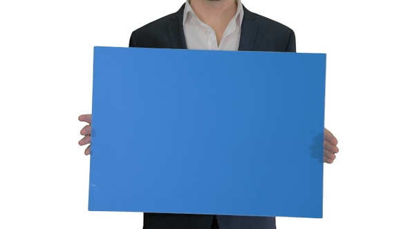 Man in suit holding a blank board on white background.