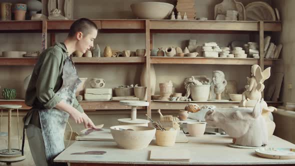 Woman Preparing Tools for Work in Pottery Studio