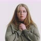 Hopeful Woman Puts Hands to Chest Posing for Camera on White - VideoHive Item for Sale