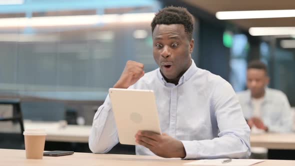 Successful African Businessman Celebrating on Tablet