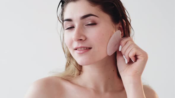 Gua Sha Facial Massage Woman with Face Quartz Tool
