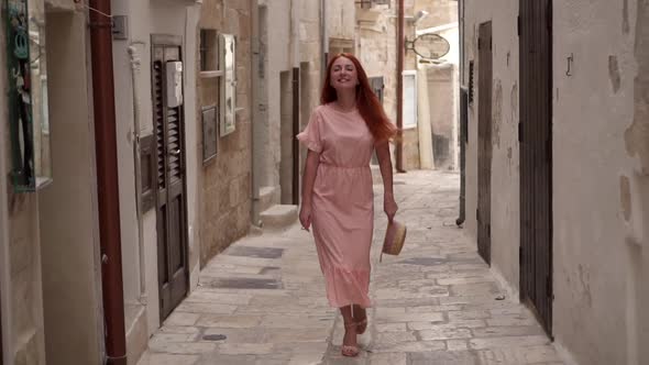 Happy Young Woman Tourist Walking Through Streets of Old European City Slow Motion