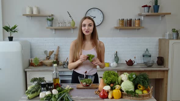Girl Throwing Pieces of Lettuce on Plate, Telling the Recipe. Cooking Salad with Raw Vegetables