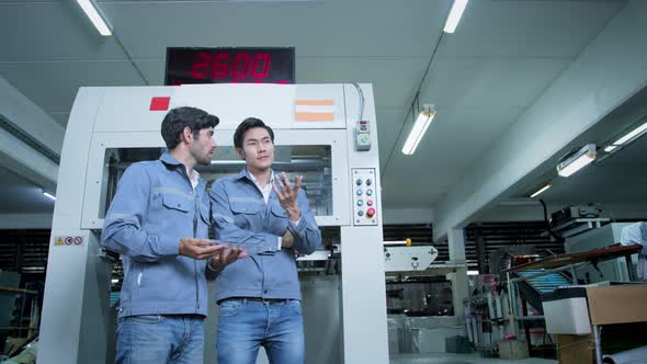 specialist worker engineer team control and operate printing package lable machine